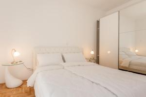 Postel nebo postele na pokoji v ubytování Apartments Kukuriku