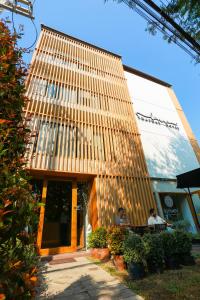 two people sitting at a table outside of a building at Lanna Thaphae Hotel in Chiang Mai