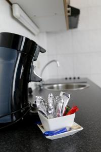 a kitchen counter with a coffee maker and some foil at Appartementen Valkenburg in Valkenburg
