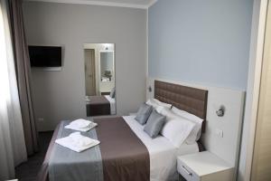 a bedroom with a large bed with two towels on it at DolceLina Home in Lampedusa