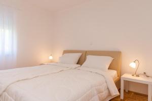 Postel nebo postele na pokoji v ubytování Apartments Kukuriku