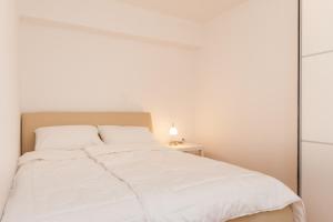 Postel nebo postele na pokoji v ubytování Apartments Kukuriku