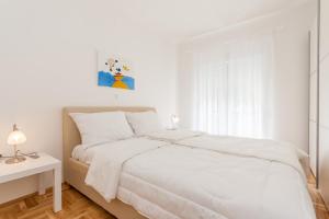 Postel nebo postele na pokoji v ubytování Apartments Kukuriku