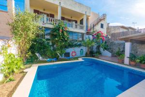 a villa with a swimming pool in front of a house at Maia in Moscari