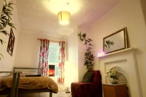 a bedroom with a bed and a chair and a window at City Centre Cambridge next to regent street in Cambridge