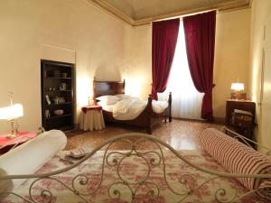 a bedroom with a bed and red curtains at Antica Casa Zucchini B&B in Bologna
