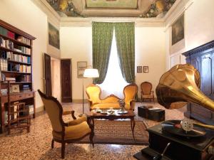 a living room filled with furniture and a large window at Antica Casa Zucchini B&B in Bologna