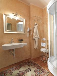 a bathroom with a sink and a mirror and a shower at Antica Casa Zucchini B&B in Bologna