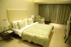 a hotel room with a bed and a chair at Verdun Suites Hotel in Beirut