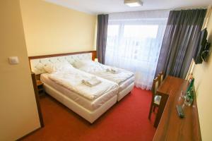 Postel nebo postele na pokoji v ubytování Hotel SiLL