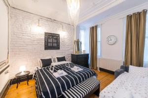 a bedroom with two beds and a brick wall at Galata Chic Delux Flats in Istanbul