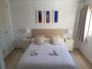 a bedroom with a large white bed with two pillows at Sea Two in Port de Pollensa