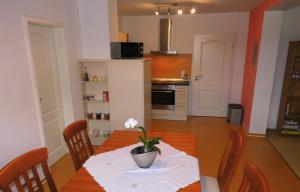 a kitchen with a table with a vase of flowers on it at Ferienwohnung Kirchbergblick in Thale