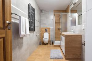 łazienka z toaletą i umywalką w obiekcie Apartament Loft w mieście Augustów