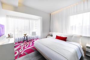A bed or beds in a room at Mode Sathorn Hotel - SHA Extra Plus