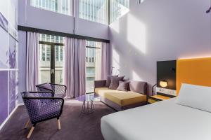 a hotel room with a bed and a couch at Room Mate Bruno, Rotterdam in Rotterdam