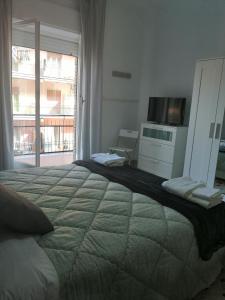 a bedroom with a large bed and a television at B&B LA DOLCE VITA in Gragnano