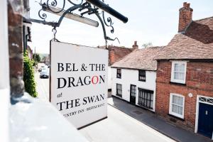 
a street sign on a pole in front of a building at Bel and The Dragon-Kingsclere in Kingsclere
