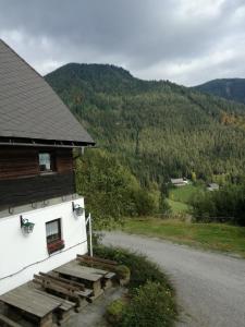 a building with wooden steps next to a road at Biohof Sattler in Etmissl