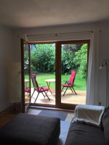 a bedroom with a patio with two chairs and a table at Top Appartement 2 in Rosengarten/Hamburg in Rosengarten