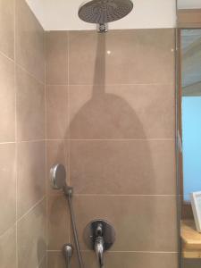 a shower stall with a shadow of a shower head at Top Appartement 2 in Rosengarten/Hamburg in Rosengarten