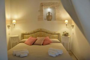 Säng eller sängar i ett rum på Trulli MADIA Luxury Alberobello