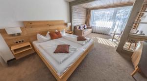 Säng eller sängar i ett rum på Hotel Quellenhof