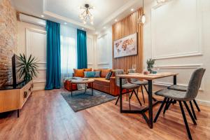 a living room with a couch and a table at Miha Luxury Apartment Card Payment 2BR 50m from Main Square in Belgrade