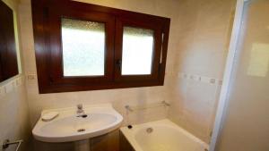 a bathroom with a sink and a window and a tub at Global Immo 8005 Casa Muga in Pau +16 photos
