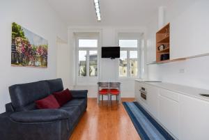 a living room with a couch and a table at IN PORTO - Santa Catarina Apartment in Porto