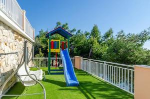 a playground with a slide and a slideintend at Vila petra in Prizba