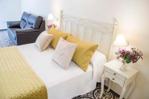 מיטה או מיטות בחדר ב-Hostal Boutique Casa La Laja