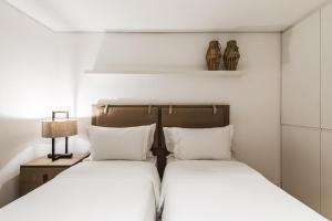 dos camas sentadas una al lado de la otra en un dormitorio en Casa Amarela en Fernando de Noronha