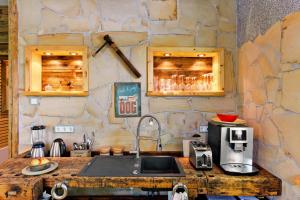 a kitchen with a sink and a stone wall at Ferienwohnung Chiara in Oybin