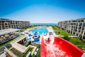 a man riding a water slide at a resort at Premier Fort Beach Hotel in Sveti Vlas