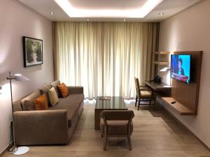 a living room with a couch and a table at Hotel Elais Kinshasa in Kinshasa