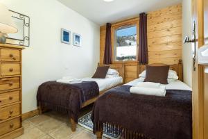 A bed or beds in a room at APARTMENT KANDAHAR - Alpes Travel - Central Chamonix - Sleeps 4