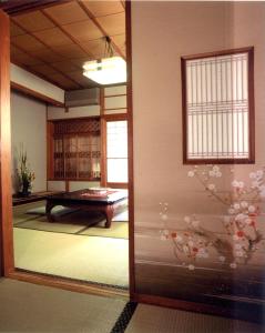 a room with a view of a room with a table at Hinodeya in Ito