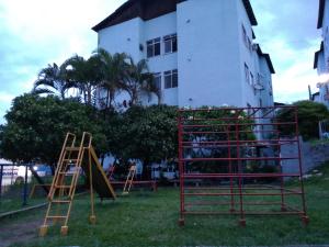 a group of playground equipment in front of a building at Campo Grande Pousar ou morar in Rio de Janeiro