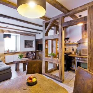 a kitchen and living room with wooden beams at Red Rock Resort in Kurort Oybin