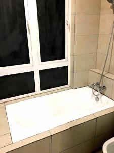 a bathroom with a shower and a sink and two windows at Excellent Location Premium Studio at Palo 101 Ipoh in Ipoh