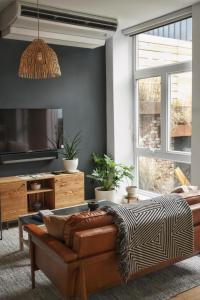 a living room with a couch and a table at Lokal Hotel Fishtown in Philadelphia