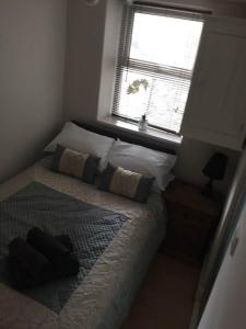 a bedroom with a large bed with a window at Awel Y Mor in Barmouth