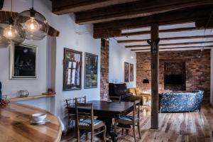 a living room with a table and chairs and a fireplace at Apartament GALERIA in Zielona Góra