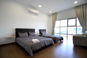 a bedroom with a bed and a couch and a window at Zeta Desky in Kuala Lumpur