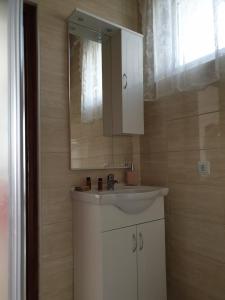 a bathroom with a white sink and a mirror at Apartmani Hršak in Krapina +33 photos