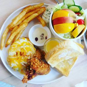 a plate of food with french fries and french toast at Sinmanizu Homestay in Hengchun South Gate