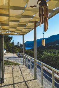 a pergola with a view of the mountains at Av Apartment in Agios Nikitas