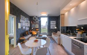 a kitchen and living room with a table and chairs at Residenza Porta Volta in Milan