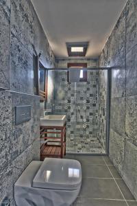 a bathroom with a toilet and a sink and a shower at Vintage Villas in Kusadası